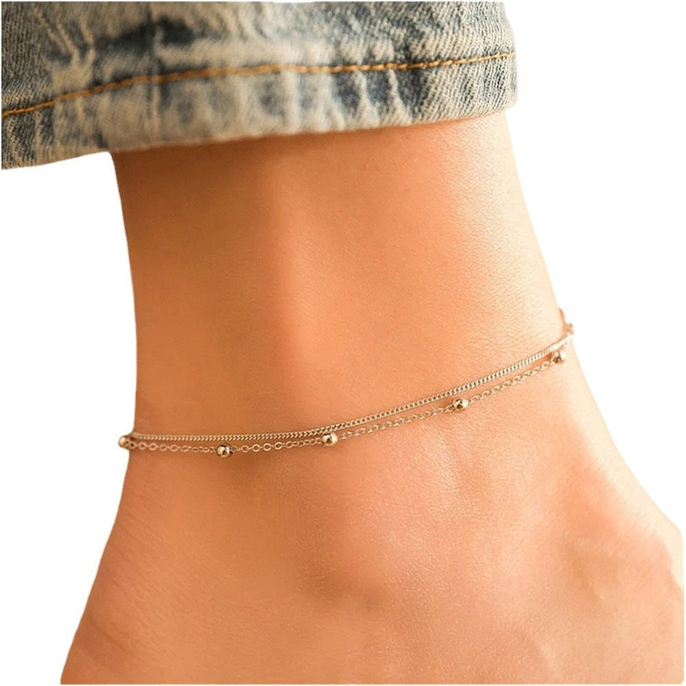 Stilvolles und schlichtes Fußkettchen für Damen mit leichter Luxus-Kupferperle und Doppelschicht-Ornament